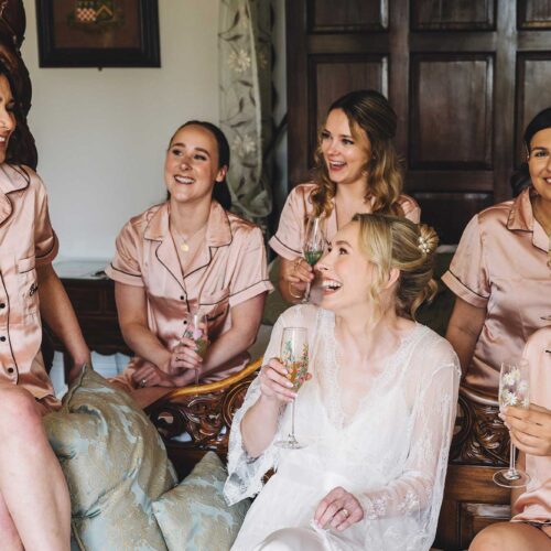 Bride-and-bridesmaids-in-pyjamas-enjoying-a-drink-together-in-the-Homme-House-Main-Suite
