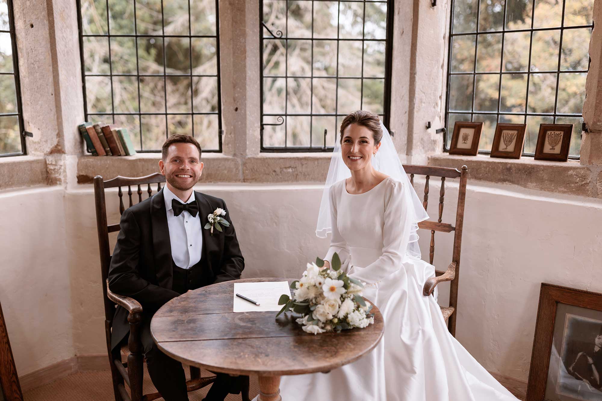 Bride-and-groom-signing-marriage-register-in-Summerhouse-at-Homme-House