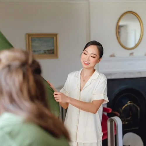 Bride-inspects-bridesmaid-dress-in-Homme-House-Main-Suite-Drawing-Room