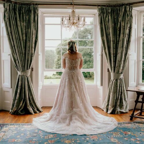 Bride-looking-out-of-the-window-in-the-Homme-House-main-suite