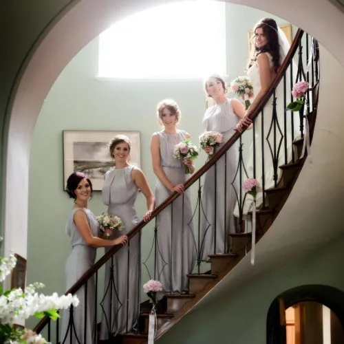 Bride and bridesmaids on the flying staircase at Homme House