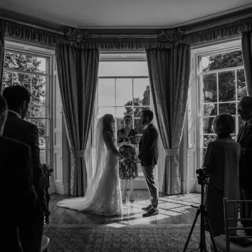 Bride and groom facing during humanist wedding ceremony at Homme House