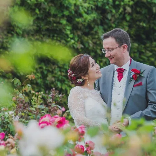 Bride and groom in the rose garden at Homme House