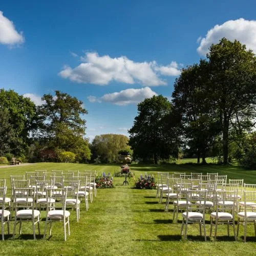 Wedding ceremony furniture on lawn at Homme House