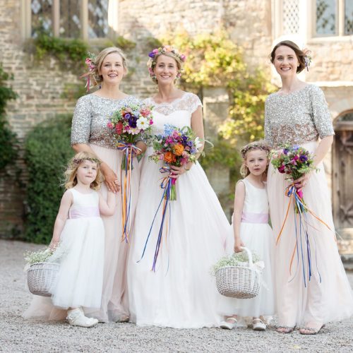 Bride, bridesmaids and flower girls in front of the Tower wing at Homme House