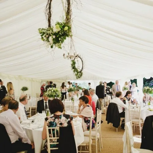 Wedding guests in marquee at Homme House