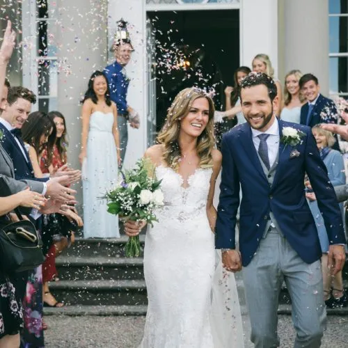 Wedding couple showered with confetti following wedding ceremony at Homme House