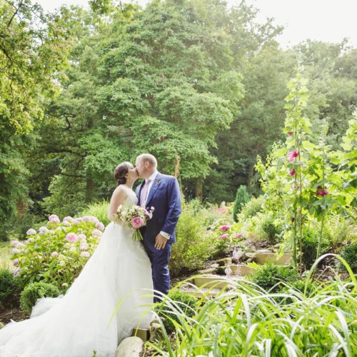 Wedding couple portrait beside water garden