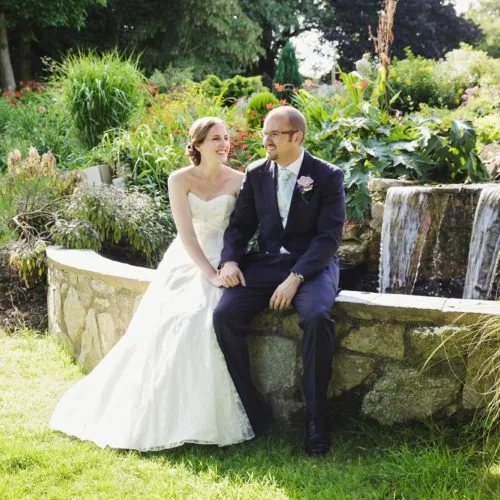 Wedding couple beside water feature