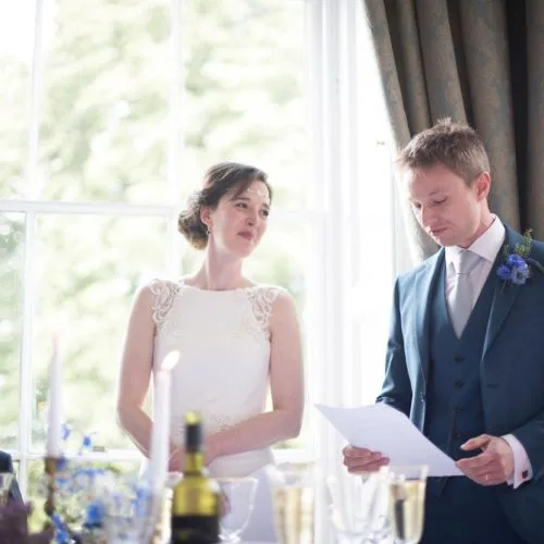 Bride and groom giving a wedding speech together at Homme House