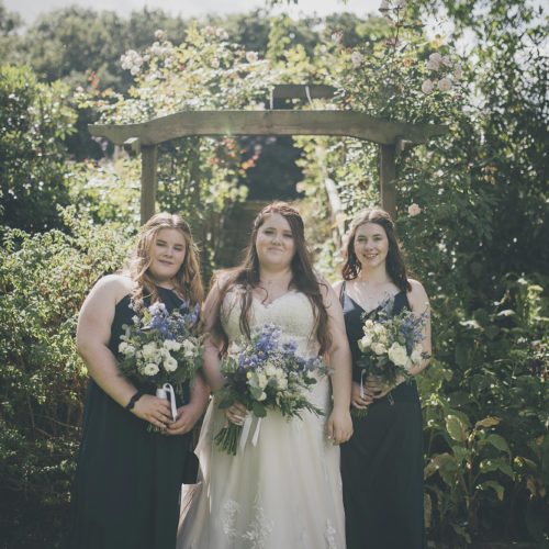 Bride and bridesmaids in front of pergola steps at Homme House