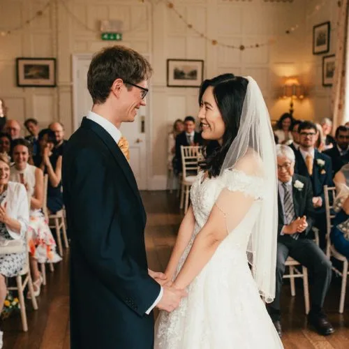 A wedding couple exchange vows during a Panelled Room wedding ceremony at Homme House
