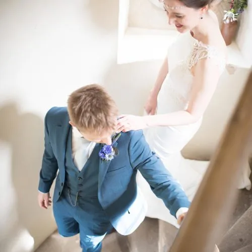 A bride and groom descend the Summerhouse spiral staircase at Homme House
