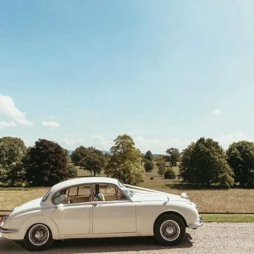 A wedding car in front of Homme House\'s historic parkland