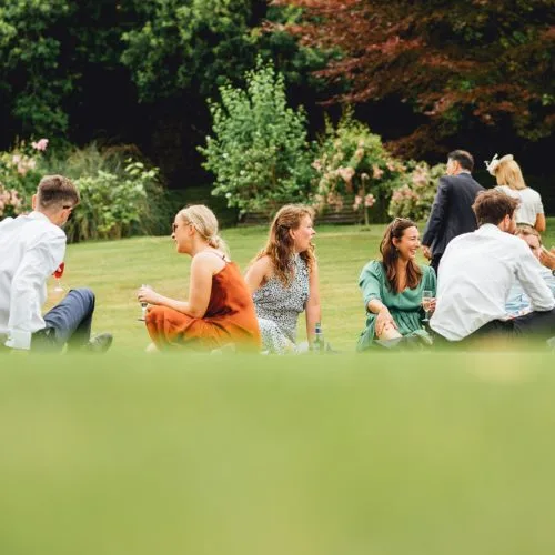 Guests sitting on the main lawn at Homme House