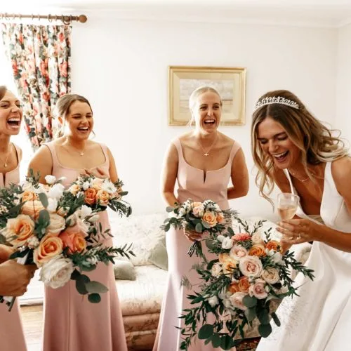 Bride and Bridesmaids Laughing in the Bridal Drawing Room at Homme House