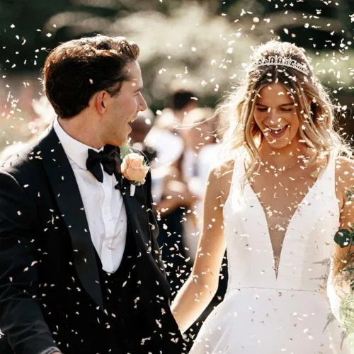 Bride and groom showered with confetti
