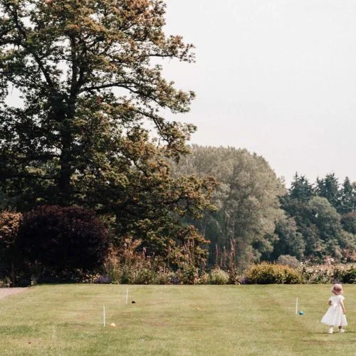 Children playing on the croquet lawn