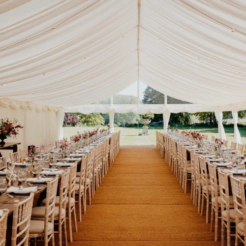 Banqueting-style-seating-in-summer-marquee-at-Homme-House