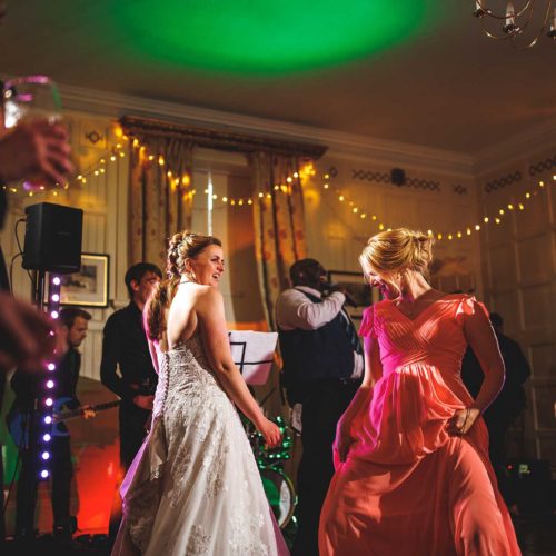 Bride-and-bridesmaid-dancing-in-Homme-House-Panelled-Room