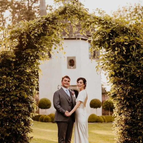 Bride-and-groom-in-evening-sunshine-outside-Homme-House-Summerhouse2