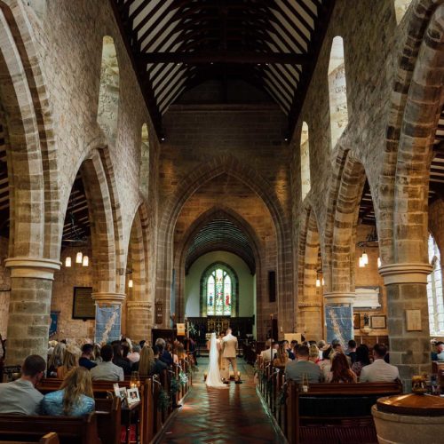 Bride-and-groom-in-nave-of-church