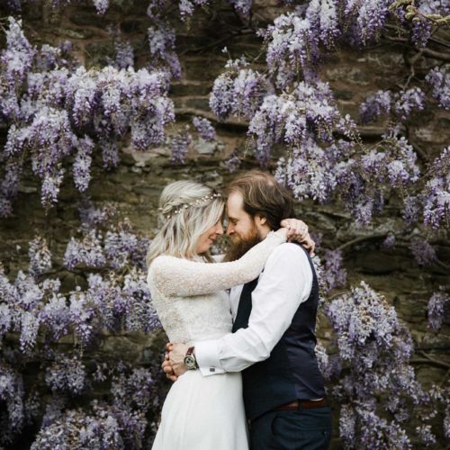 Bride-and-groom-portrait-in-front-of-wisteria