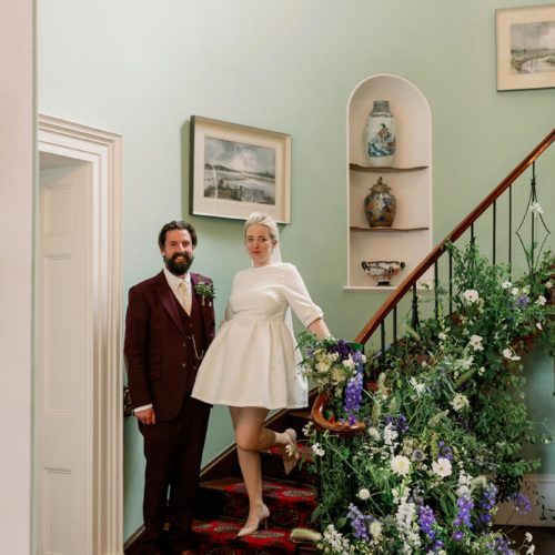Bride-and-groom-pose-on-staircase-at-Homme-House