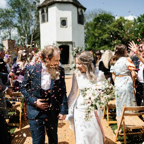 Bride-and-groom-showered-with-confetti-at-Homme-House-outdoor-wedding