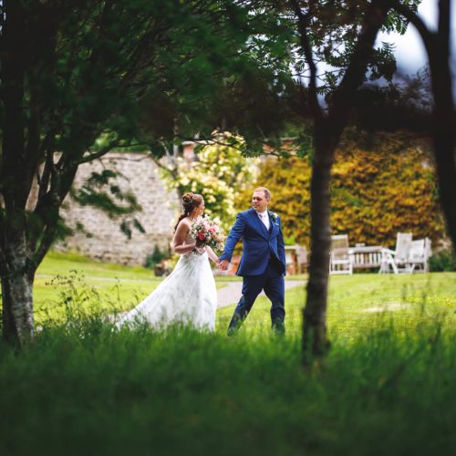 Bride-and-groom-walking-in-main-garden-at-Homme-House