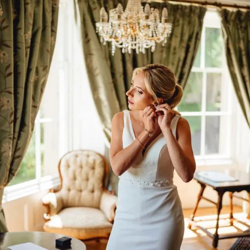 Bride-puts-earrings-on-in-Homme-House-Bridal-Suite