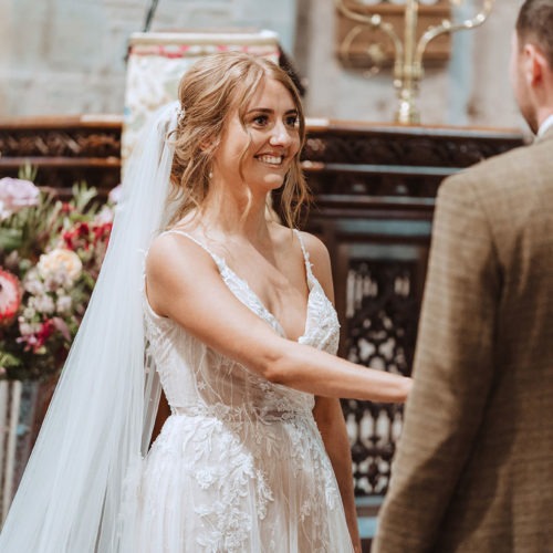 Bride-smiling-at-husband-to-be-in-church