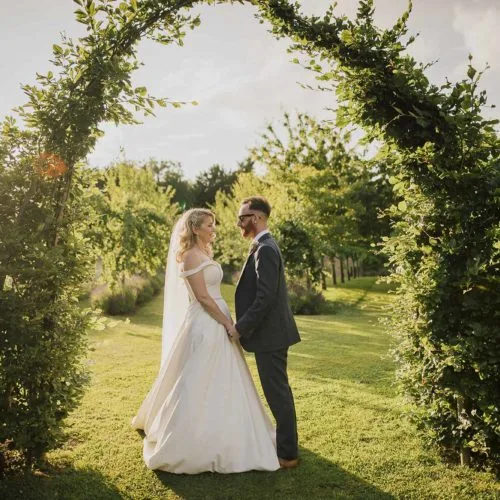 Couple-in-sunlight-under-beech-arch