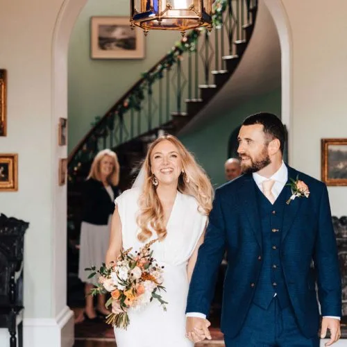 Couple-leave-wedding-ceremony-in-Hall-at-Homme-House