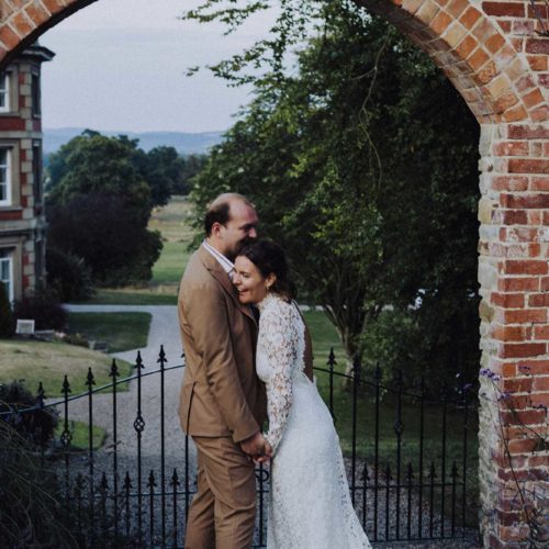 Couple-portrait-at-gates-to-walled-garden-at-Homme-House