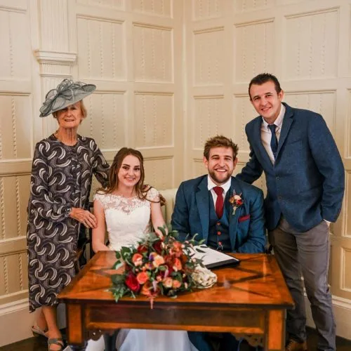 Couple-sign-marriage-register-with-witesses-at-Homme-House