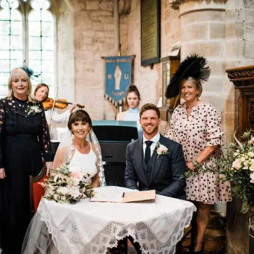 Couple-sign-register-at-marriage-service