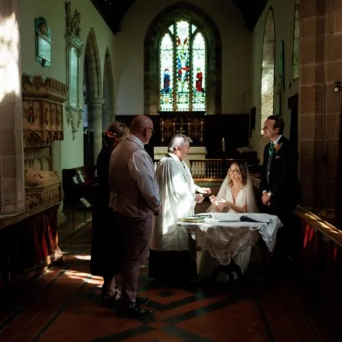 Couple-signing-marriage-register-at-St.Bartholomews-Church