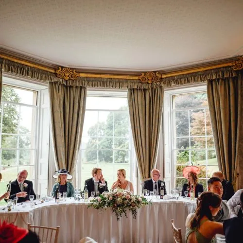 Curved-top-table-in-bay-window-at-Homme-House-wedding