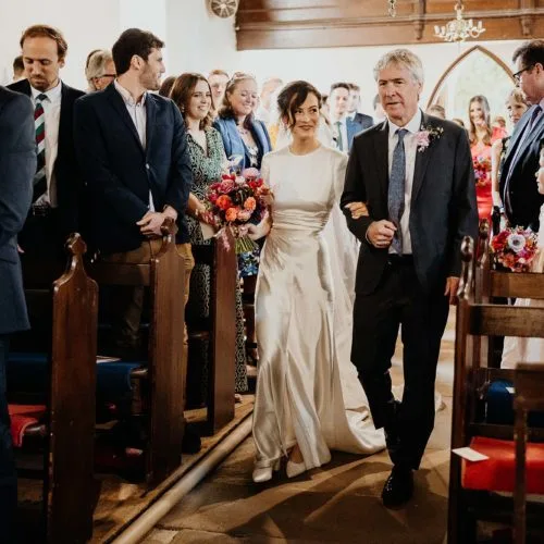 Entrance-of-the-bride-at-wedding-service-at-Yatton-church