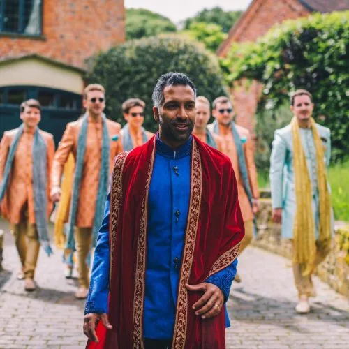 Groom-and-groomsman-walk-down-Coach-House-drive