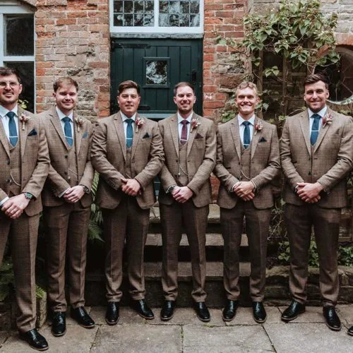 Groom-and-groomsmen-portrait-in-Coach-House-courtyard-garden