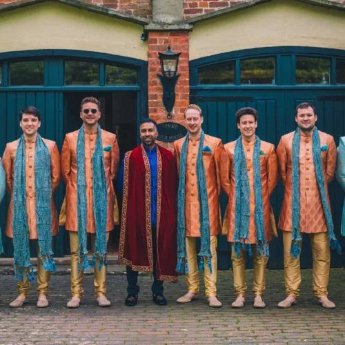 Groom-and-groomsmen-portrait-outside-Coach-House