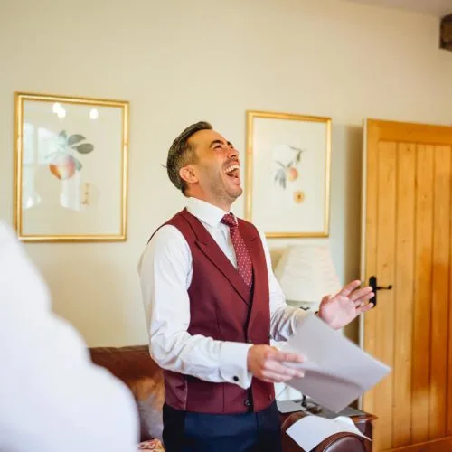 Groom-laughs-in-Coach-House-drawing-room