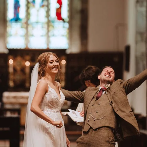 Groom-triumphant-on-being-married-in-church