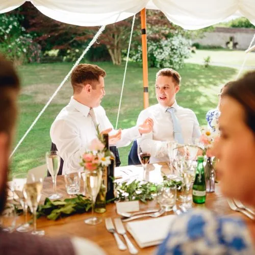 Guests-enjoy-wedding-breakfast-in-marquee-at-Homme-House