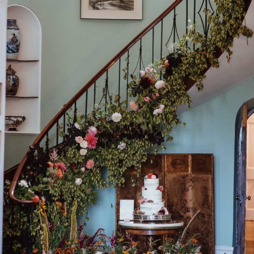 Homme-House-Hall-staircase-decorated-with-flowers