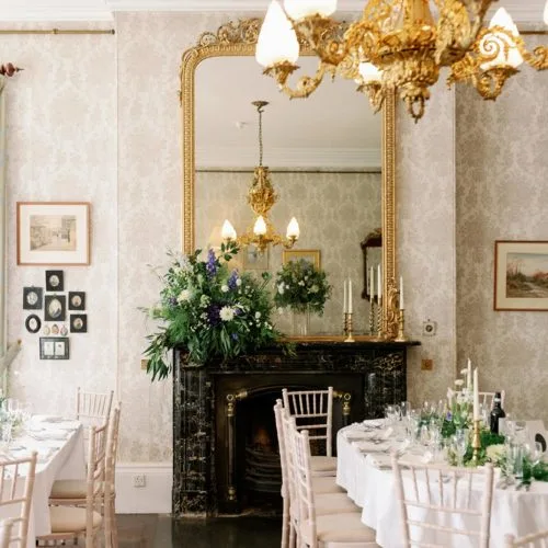 Homme-House-dining-room-with-mantelpiece-floral-display