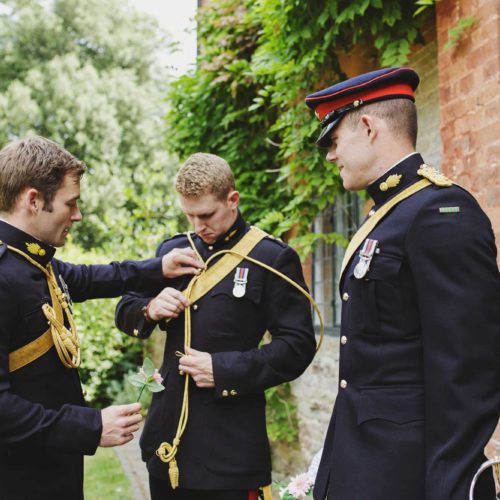 Military-officers-prepare-for-wedding-outside-Coach-House