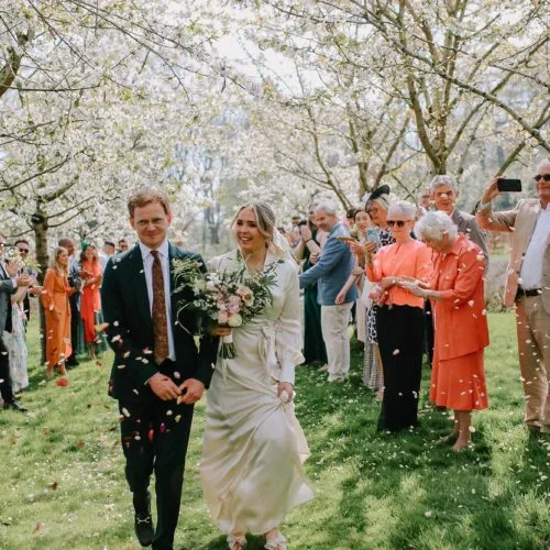 Wedding-couple-confetti-shot-under-Homme-House-blossom